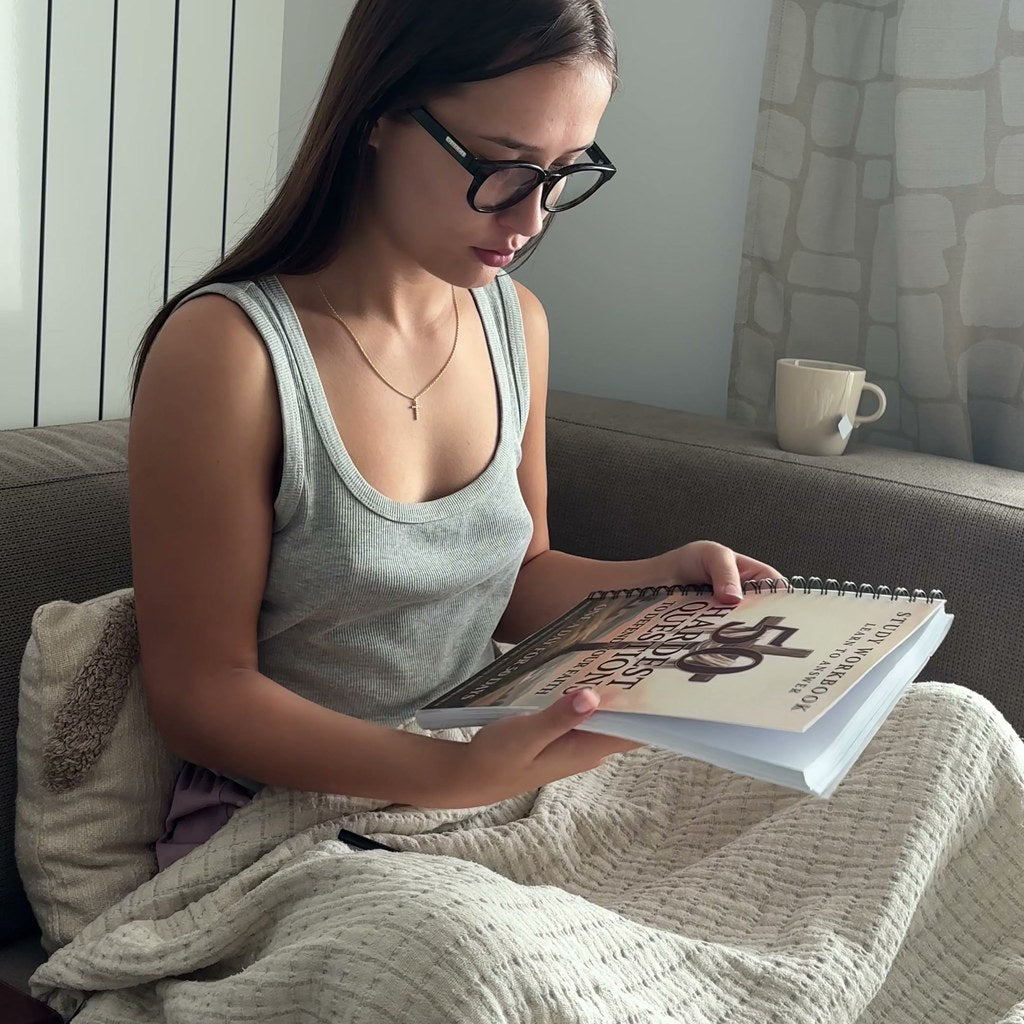 Reading the printed workbook on the couch